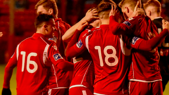 Shelbourne football club players celebrate a goal during a first division match