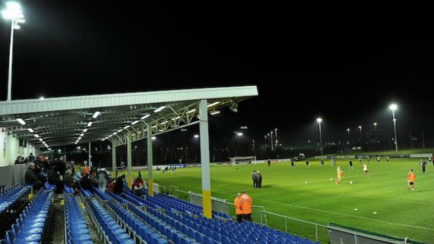 Image of a football pitch and audience stands