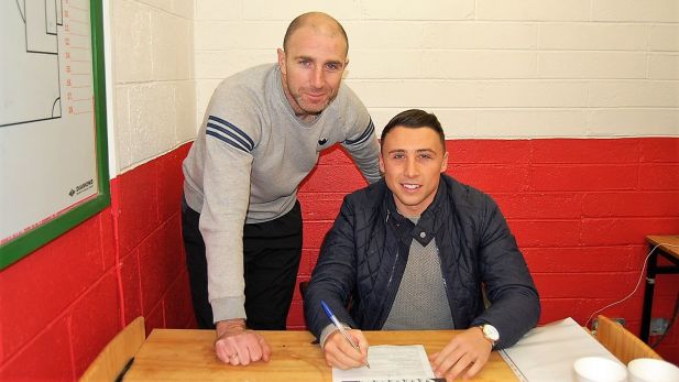 An Image of Owen Heary securing the signing of Chris Lyons.