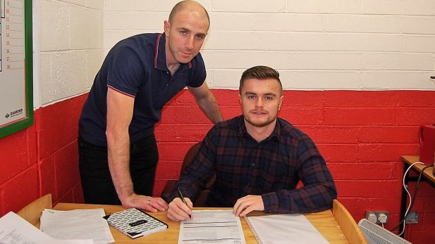 An Image of Owen Heary securing the signing of Lorcan Shannon for Shelbourne FC.