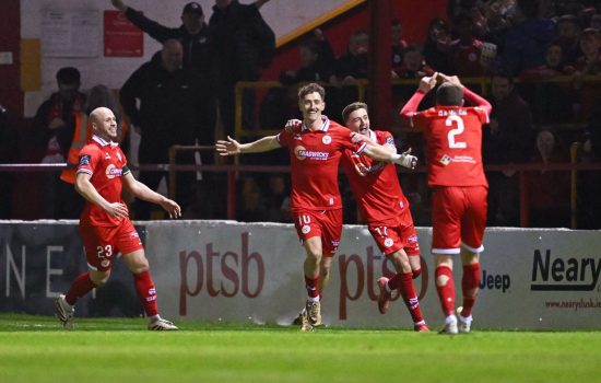 9 March 2026; John Martin of Shelbourne celebrates with teammates after scoring their side's second goal during the SSE Airtricity Men's Premier Division match between Shelbourne and Shamrock Rovers at Tolka Park in Dublin. Photo by Ramsey Cardy/Sportsfile
